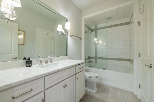 full bathroom with vanity, tiled shower / bath, and toilet