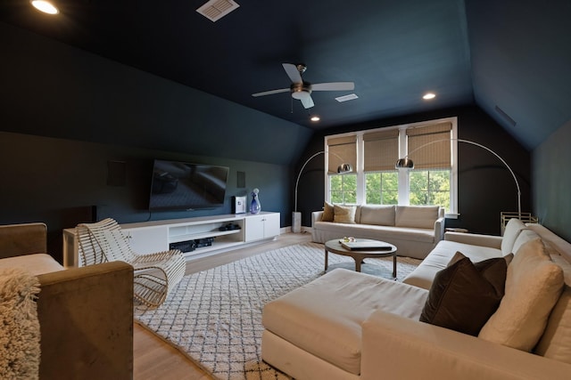 living room with vaulted ceiling, ceiling fan, and light wood-type flooring