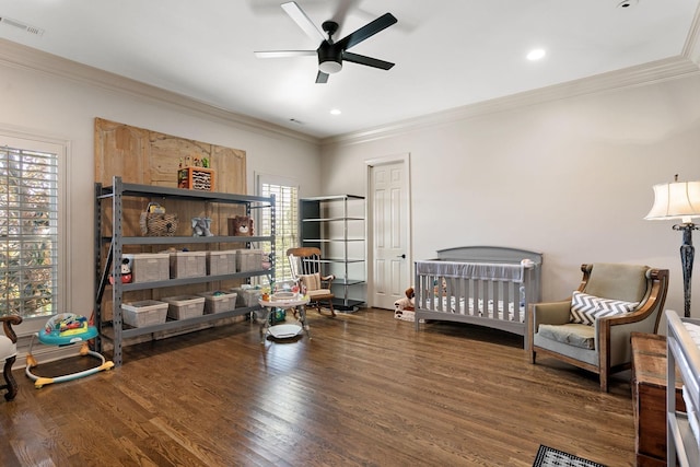 bedroom featuring crown molding, dark hardwood / wood-style floors, and ceiling fan