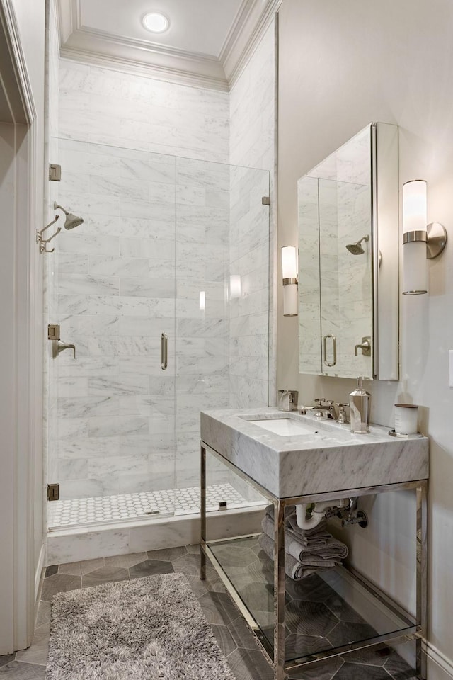 bathroom featuring crown molding and a shower with shower door