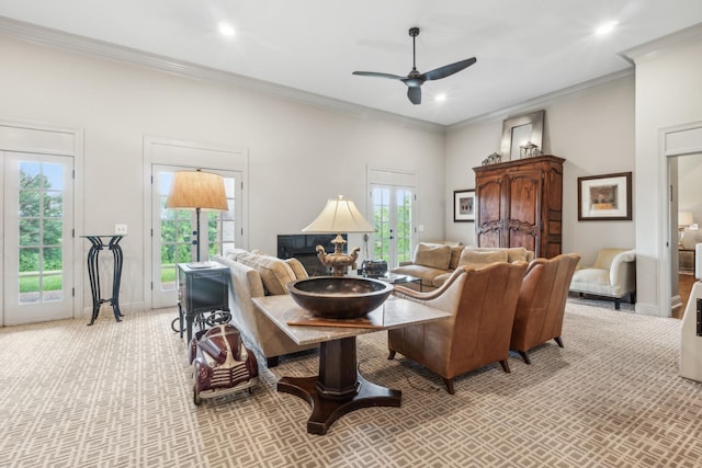 carpeted living room with ornamental molding and ceiling fan