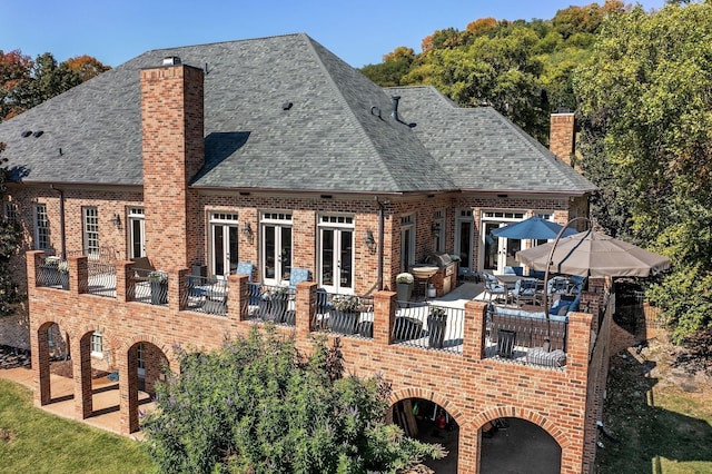 rear view of house featuring a patio area and french doors