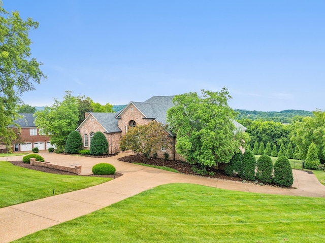 view of front of house with a garage and a front yard