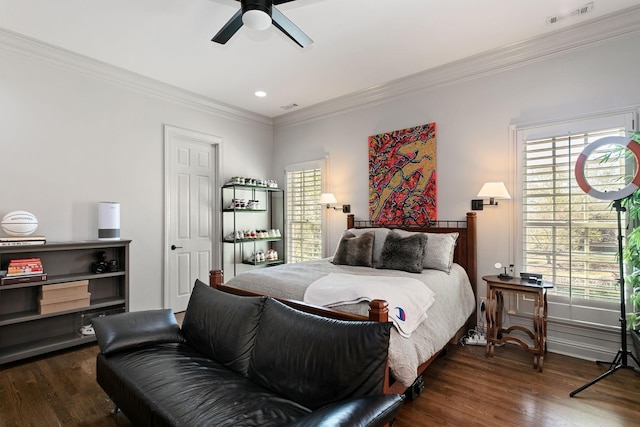 bedroom with dark hardwood / wood-style flooring, crown molding, and ceiling fan