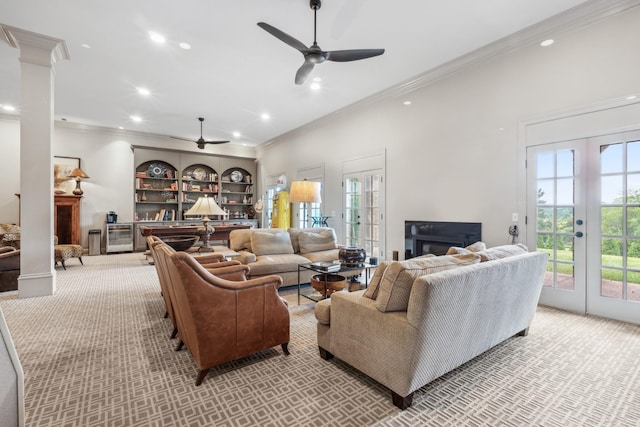 living room featuring ornamental molding, light colored carpet, ceiling fan, and french doors