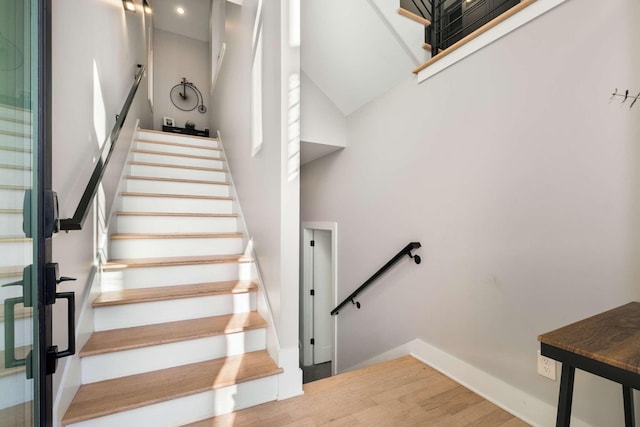 stairs featuring wood finished floors