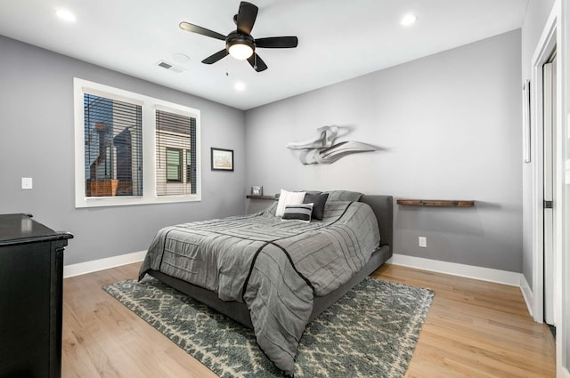 bedroom with recessed lighting, visible vents, a ceiling fan, wood finished floors, and baseboards