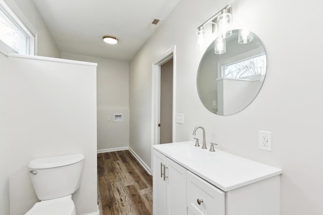 bathroom with vanity, hardwood / wood-style floors, and toilet