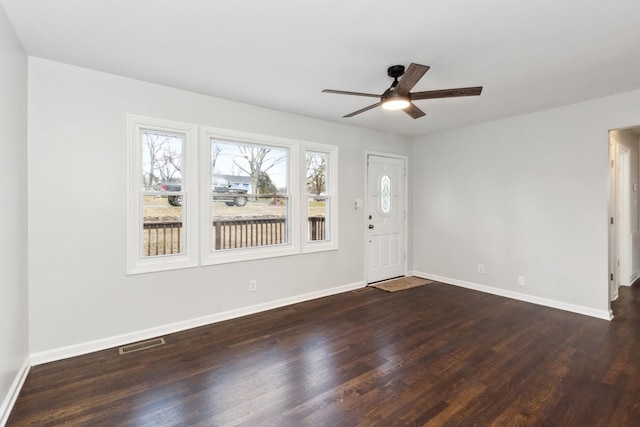 foyer with dark hardwood / wood-style flooring and ceiling fan