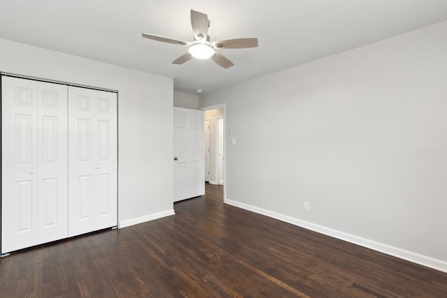 unfurnished bedroom featuring dark hardwood / wood-style flooring, a closet, and ceiling fan