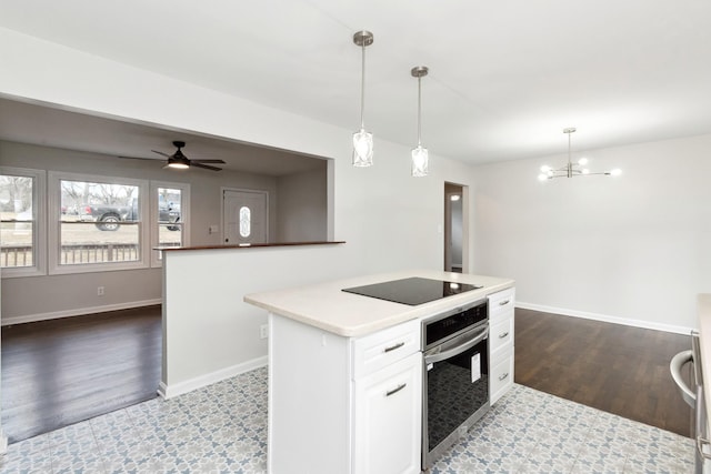 kitchen featuring white cabinetry, hanging light fixtures, a kitchen island, black electric stovetop, and oven