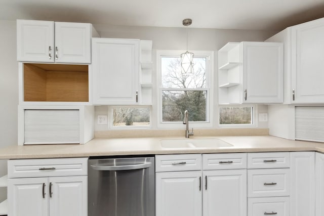 kitchen with dishwasher, sink, white cabinets, and decorative light fixtures