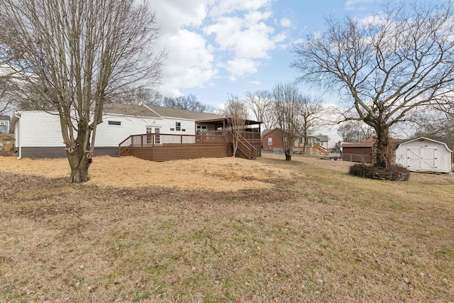 view of yard with a storage unit and a deck