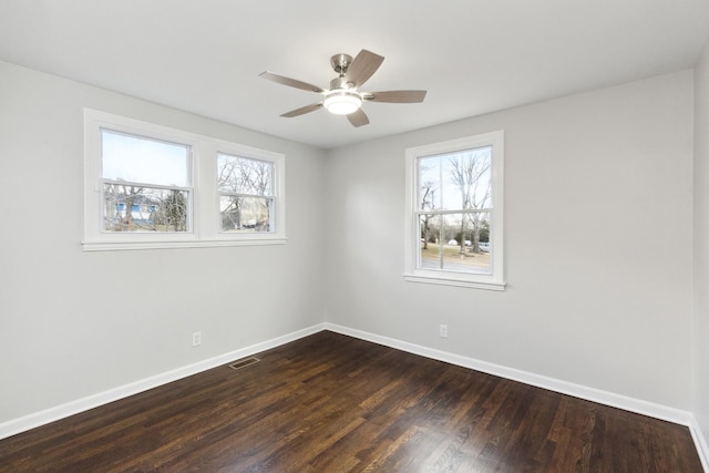 unfurnished room featuring dark hardwood / wood-style floors and ceiling fan