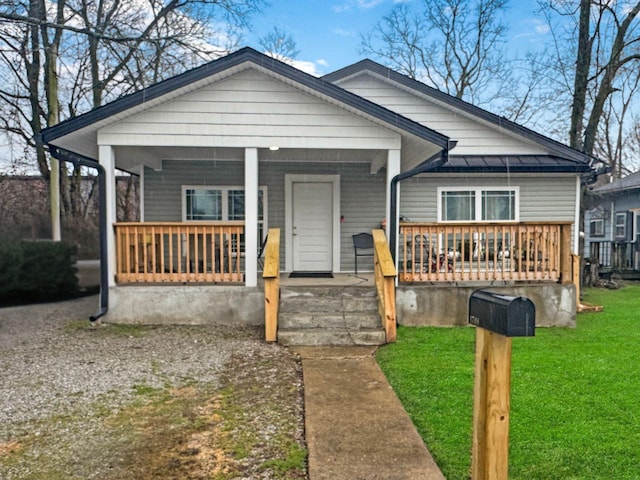 bungalow-style home featuring a porch and a front yard