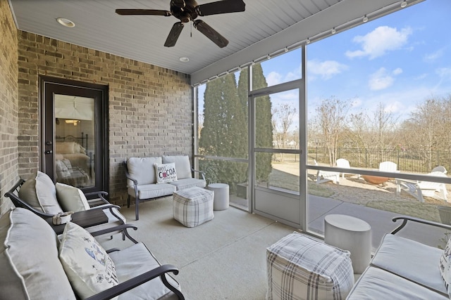 sunroom / solarium featuring a healthy amount of sunlight and ceiling fan