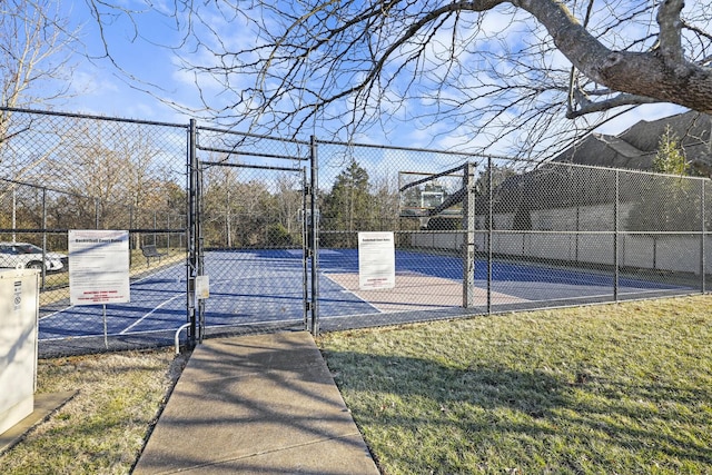 view of basketball court with a yard