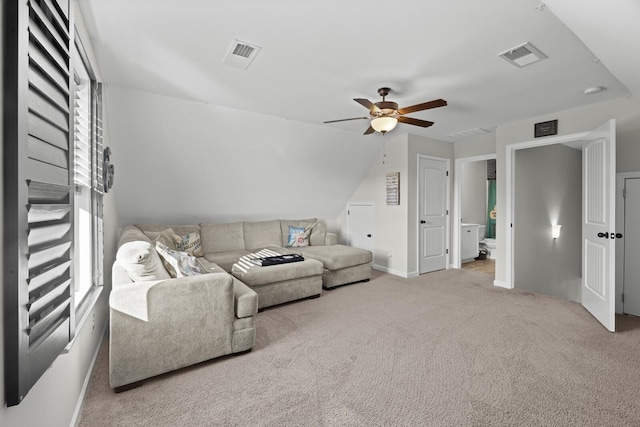 living room featuring vaulted ceiling, light colored carpet, and ceiling fan