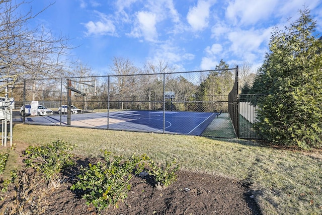 view of basketball court with a lawn