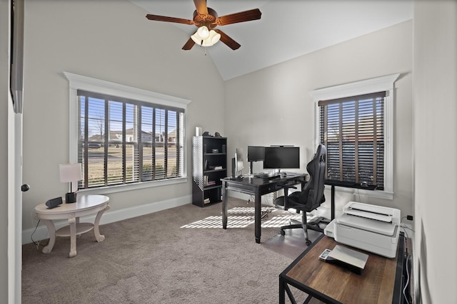 carpeted home office with lofted ceiling, plenty of natural light, and ceiling fan