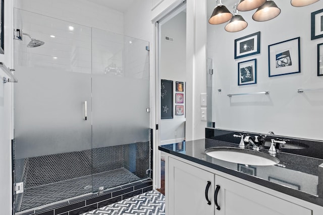 bathroom featuring vanity and an enclosed shower