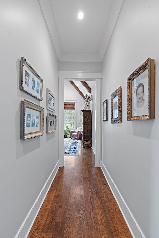 hall featuring vaulted ceiling, ornamental molding, and dark hardwood / wood-style floors