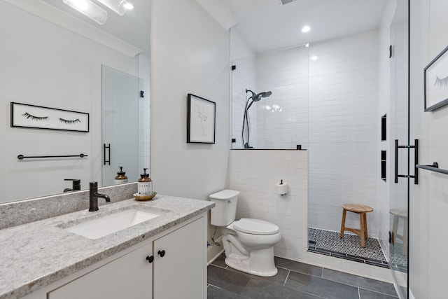 bathroom with tile patterned flooring, vanity, an enclosed shower, and toilet