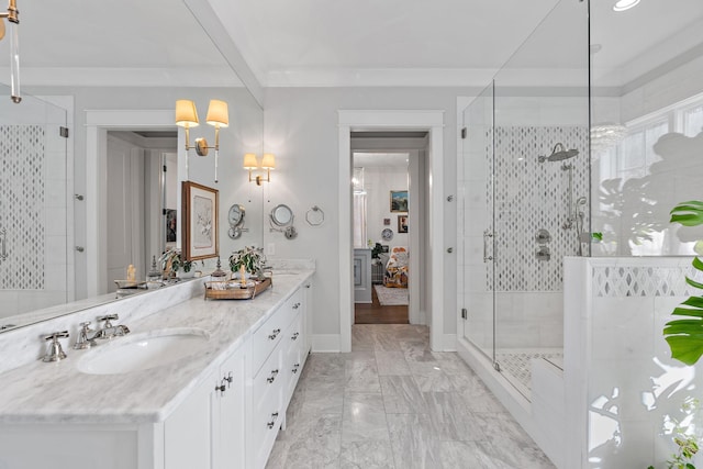 bathroom with vanity, ornamental molding, and an enclosed shower