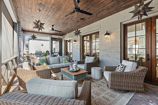 sunroom / solarium with wood ceiling, french doors, and ceiling fan