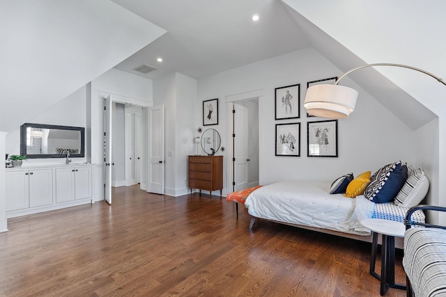 bedroom featuring sink and dark hardwood / wood-style flooring