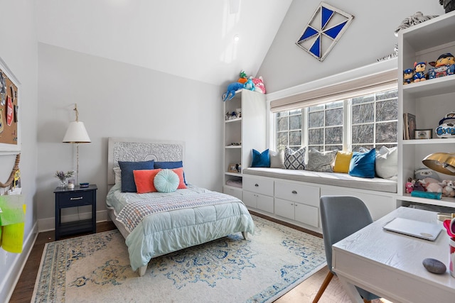 bedroom with lofted ceiling and wood-type flooring