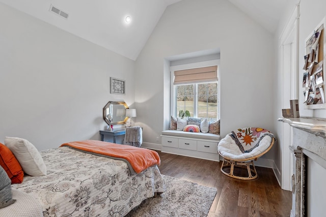 bedroom with dark hardwood / wood-style floors and high vaulted ceiling