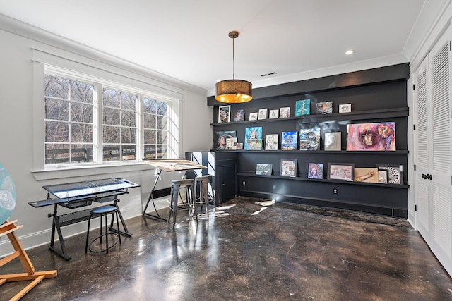 office area with ornamental molding and concrete flooring