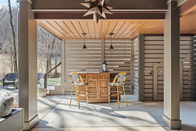 view of patio featuring ceiling fan and exterior bar