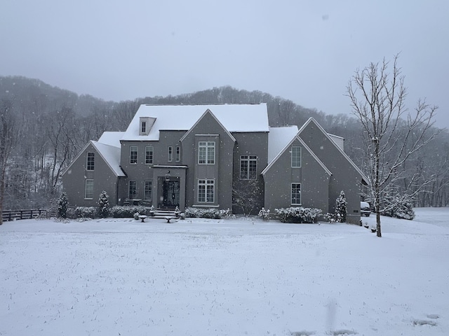 view of snow covered rear of property