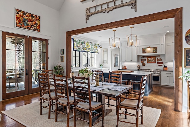 dining room with french doors, dark hardwood / wood-style floors, and high vaulted ceiling