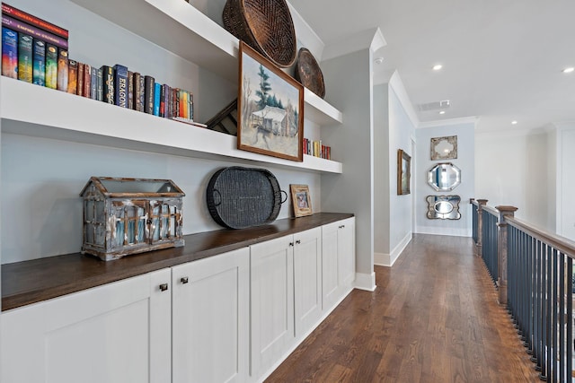 corridor with crown molding and dark hardwood / wood-style floors