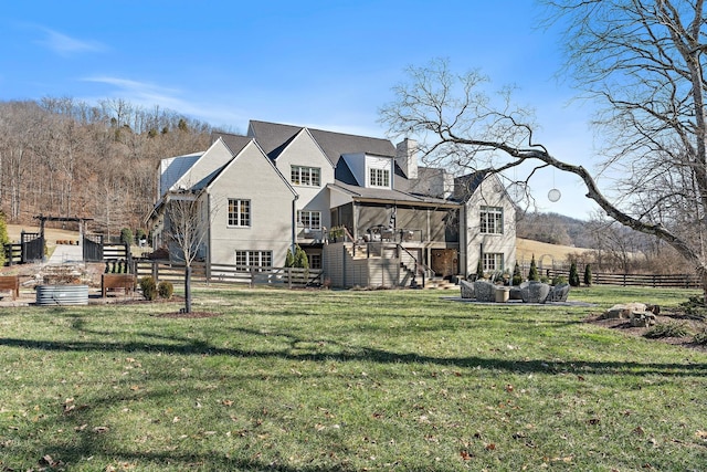 rear view of property with a lawn