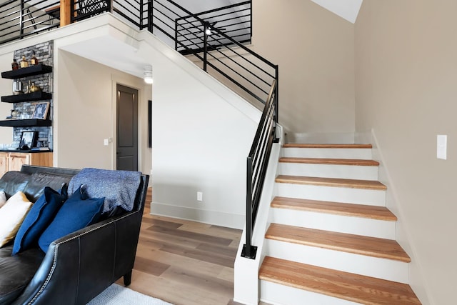 stairs with hardwood / wood-style floors