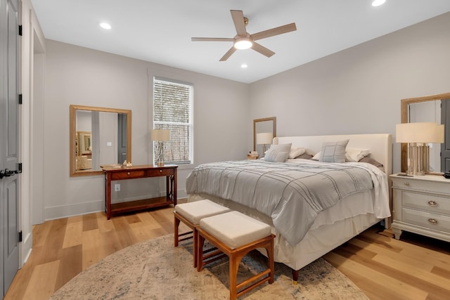 bedroom with light hardwood / wood-style floors and ceiling fan