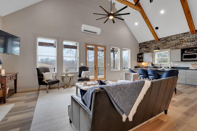 living room featuring light hardwood / wood-style flooring, beam ceiling, high vaulted ceiling, a wall mounted AC, and french doors