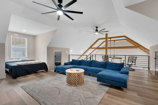 living room with lofted ceiling, hardwood / wood-style floors, and ceiling fan