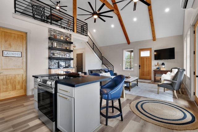 kitchen with white cabinetry, stainless steel electric range, high vaulted ceiling, and light wood-type flooring