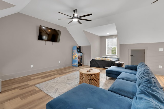 living room featuring lofted ceiling, ceiling fan, and light wood-type flooring