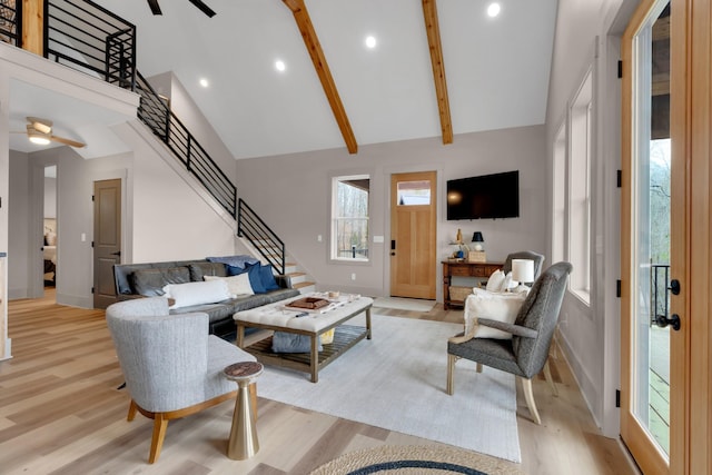 living room with beamed ceiling, ceiling fan, light hardwood / wood-style floors, and high vaulted ceiling