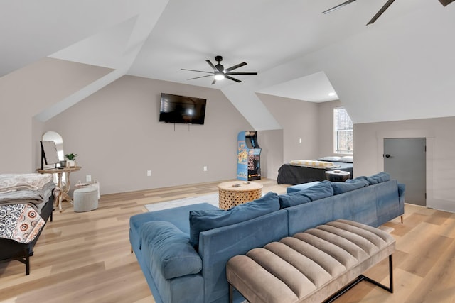 living room featuring ceiling fan, lofted ceiling, and light hardwood / wood-style flooring