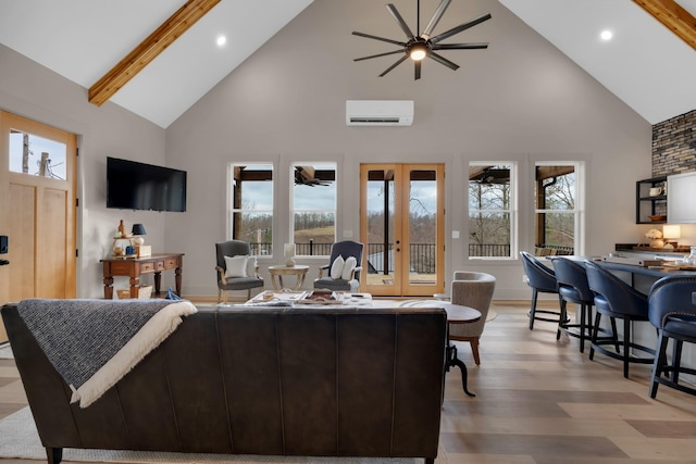 living room featuring french doors, plenty of natural light, a wall mounted AC, and beamed ceiling