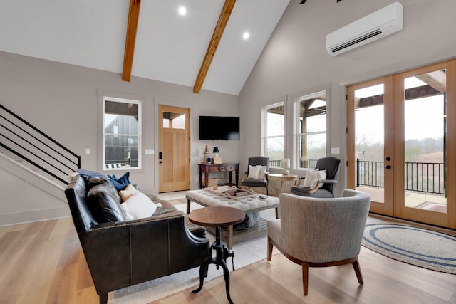 living room featuring french doors, a wall mounted AC, high vaulted ceiling, light hardwood / wood-style flooring, and beam ceiling