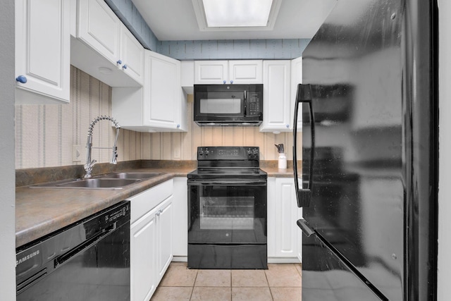 kitchen with light tile patterned flooring, sink, white cabinets, and black appliances