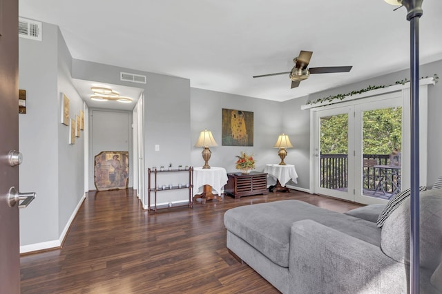 living room with dark hardwood / wood-style floors and ceiling fan